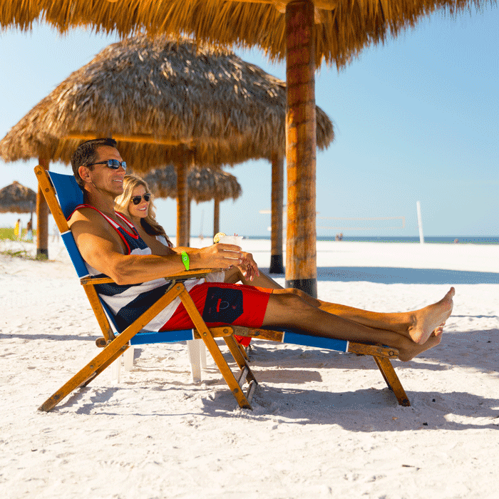 A couple relaxes on the private beach at Pink Shell Resort in Fort Myers