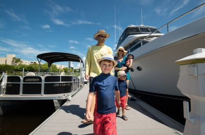 Guests walk along the marina dock at Pink Shell resort