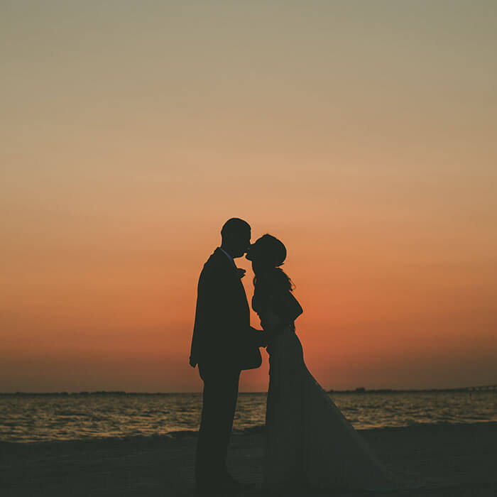 A couple shares their vows during a beachfront ceremony in Fort Myers Beach