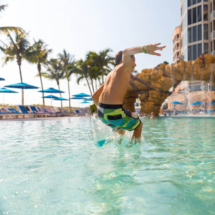 A boy jumps into the Octopool at Pink Shell Resort in Fort Myers