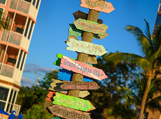 Colorful directional signs at Pink Shell Resort