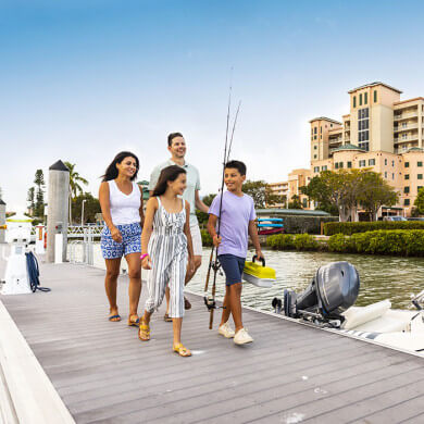 Family is walking toward their fishing charter at the Pink Shell Marina in Fort Myers Beach