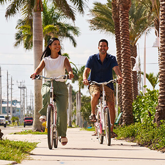 Couple biking on Estero Island Florida near Pink Shell Resort & Marina